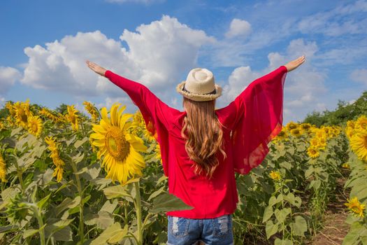 beautiful woman happy and enjoy in sunflower field