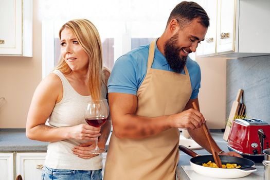 Couple in love preparing meal together in kitchen at home