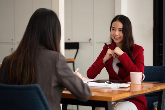 Young Asian businesswoman work together to analysis from work at the office.