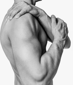 Unrecognizable shirtless man compresses his shoulder, pain in the shoulder. Monochrome image, isolated on a white background