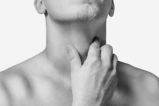 Man holds the throat, sore throat. Monochrome image, isolated on a white background