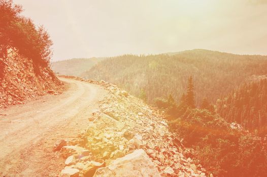 Road in the mountains. Image with sunlight effect