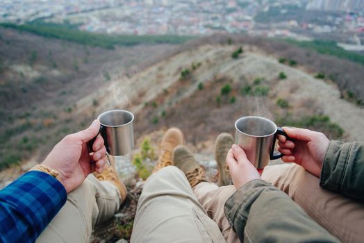 Traveler loving couple drinking tea in the mountains. Point of view shot