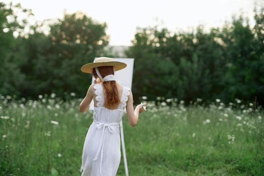 pretty woman in white dress outdoors drawing art creative. High quality photo