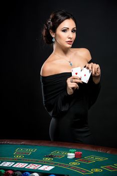 sexy woman with poker cards and chips. Female player in a beautiful black dress