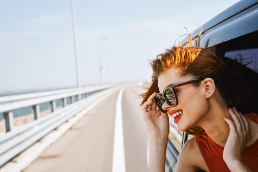 pretty woman in sunglasses rides in a travel car. High quality photo