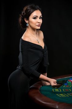 sexy woman with poker cards and chips. Female player in a beautiful black dress