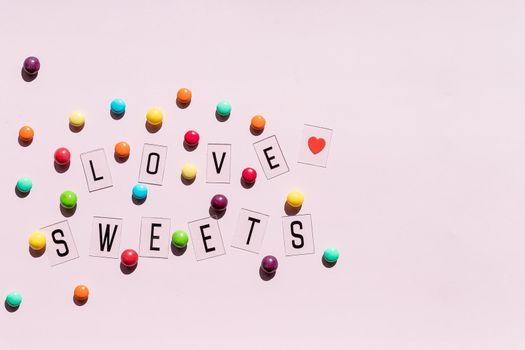 Assortment of sweet candies on color background