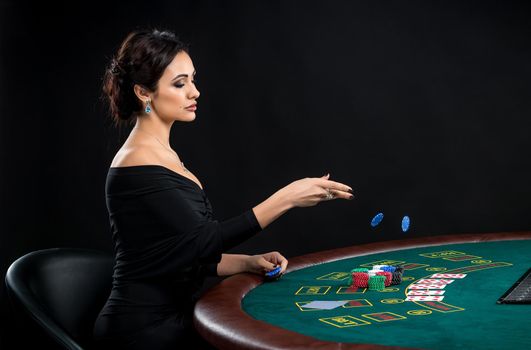 sexy woman with poker cards and chips. Female player in a beautiful black dress