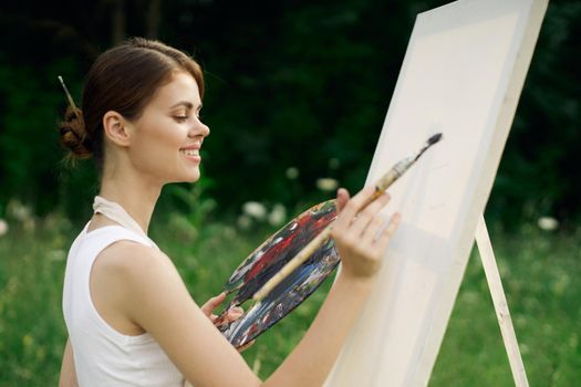 woman outdoors paint a picture landscape hobby creative. High quality photo