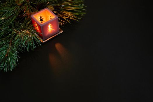 Christmas, christmas tree, candle, cones and cinnamon sticks on black background. Top view. Copy space. Still life. Flat lay. New year