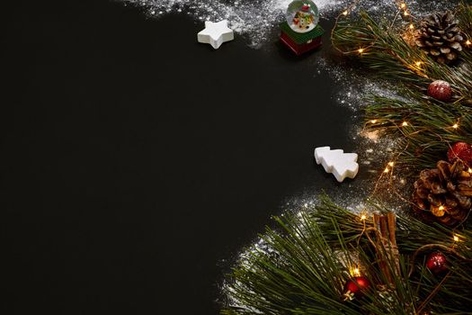 Christmas, christmas tree, colored decor, stars, balls on black background. Top view. Copy space. Still life Flat lay New year