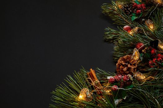 Christmas. Xmas toys and spruce branch on black background top view. Copy space. Still life. Flat lay. New year