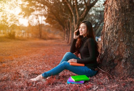 smiling woman talking on mobile phone in the park