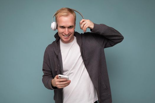 young man wearing casual white t-shirt isolated over blue background.