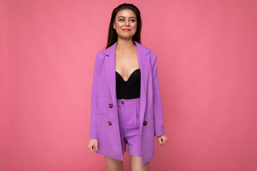 Photo of smiling young business woman wearing purple suit isolated on background. Copy space.