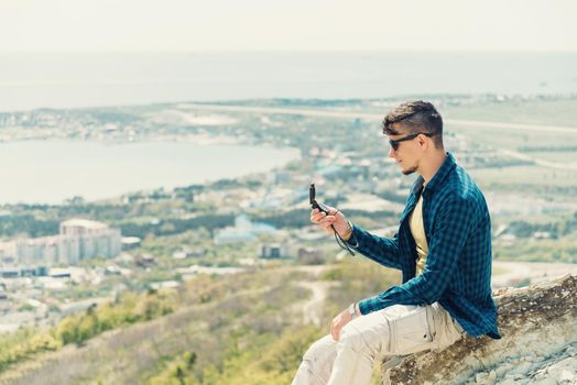 Explorer young man searching direction with a compass in summer outdoor