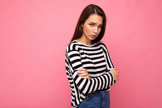 Photo shot of nice attractive pretty young sad upset brunette woman wearing casual striped longsleeve isolated over colorful background with copy space.