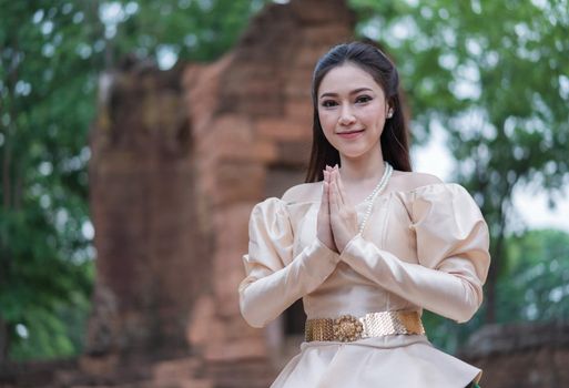 beautiful woman in Thai traditional dress is pay respect