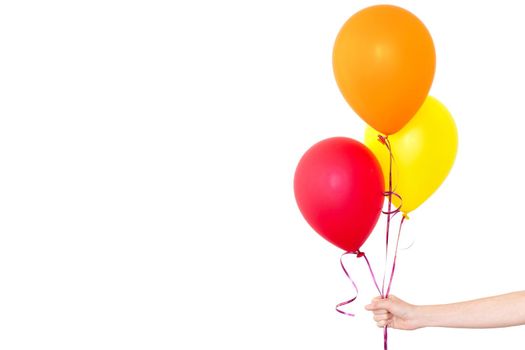 Womans hand holds balloons in a white background isolated