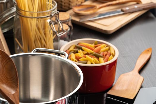 Cooking pasta at home kitchen in a pot close up