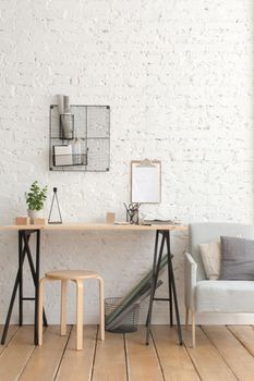 Desk with stationery in the white interior Loft workspace