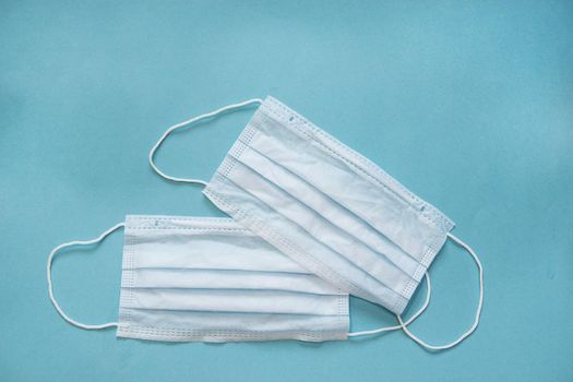 Virus prevention and treatment: wearing masks on a blue background. Space for text.