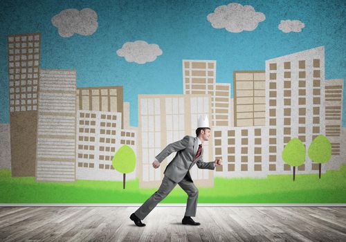 Young handsome businessman wearing white paper crown running in a hurry