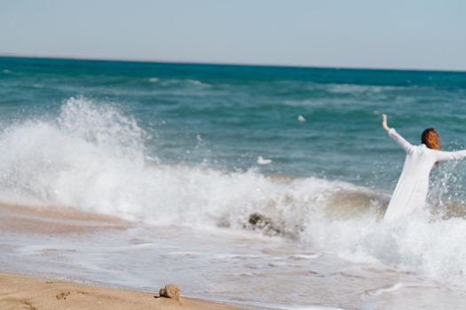 Woman in white dress near the ocean walk fresh air landscape. High quality photo