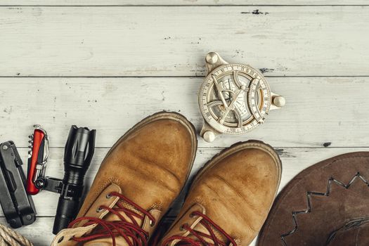 Hiking boots, compass and knife. Hiking outdoor equipment. High quality photo