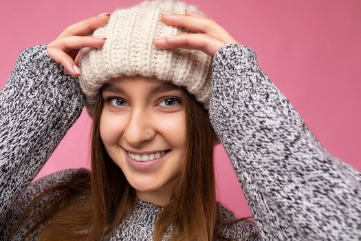 Closeup photo of pretty joyful smiling young dark blond female person standing isolated over colourful background wall wearing everyday trendy clothes looking at camera showing facial emotions.