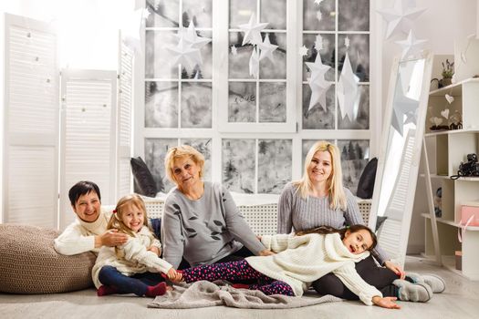 happy young family holding christmas gift and smiling.