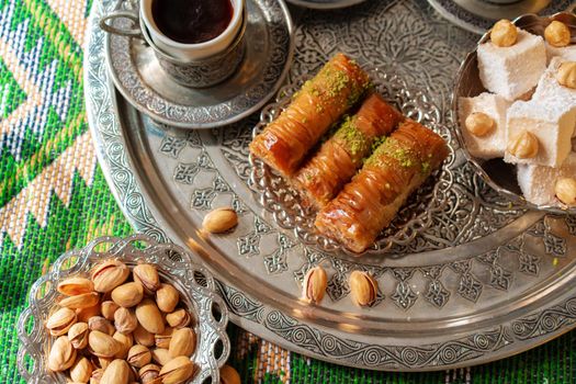 Traditional arabic dessert baklava with a cup of turkish coffee, close up