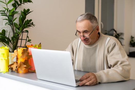 elderly man with laptop and video from grandchildren.