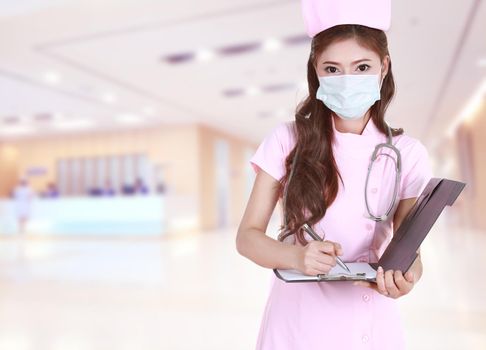 female nurse writing medical report in hospital background