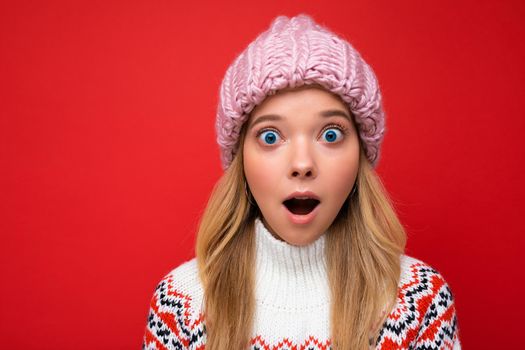 Closeup photo of beautiful shocked amazed young blonde woman standing isolated over colourful background wall wearing everyday trendy clothes looking at camera showing facial emotions.