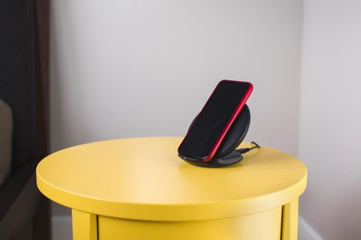 Smartphone is placed on a wireless fast charger station