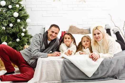 A young family with young children to bed in the bedroom.