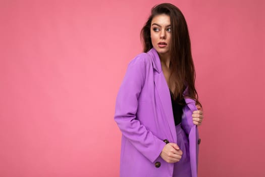 Young brunette woman nice-looking attractive charming elegant fashionable serious isolated over pink color background with empty space for text.