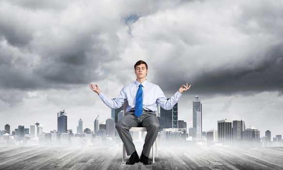 businessman sitting on an office chair, meditation and calmness