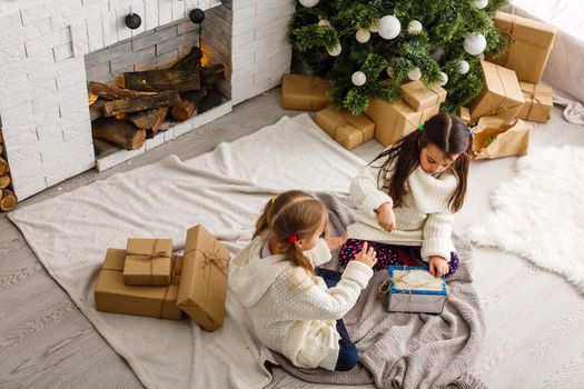 Two little girls in Christmas background.