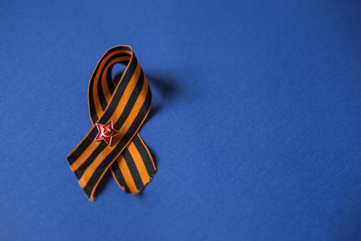 Tver Russia-may 9, 2020: 75 years of Victory in the great Patriotic war. St. George ribbon for 75 years of victory on a blue background. Happy Victory Day Space for text.