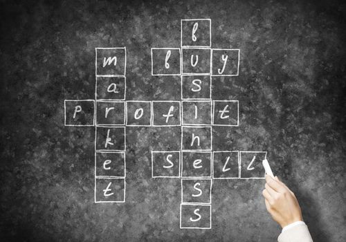 Studying concept with crossword drawn with chalk on blackboard