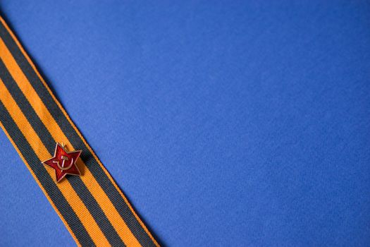 Tver Russia-may 9, 2020: 75 years of Victory in the great Patriotic war. St. George ribbon for 75 years of victory on a blue background. Happy Victory Day Space for text.