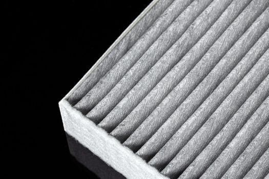 Car engine filter on dark background.