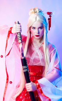 the woman dressed as a geisha with a katana