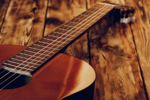 Wooden acoustic guitar body and fingerboard close up shot