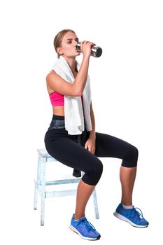 Portrait of sporty young woman tired after a gym workout. Woman with a white towel and a bottle of water isolated on white background