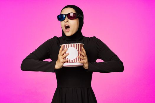 Muslim woman entertainment cinema popcorn fashion isolated background. High quality photo