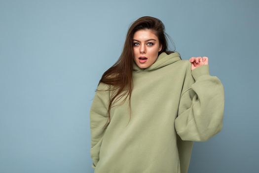 Attractive funny stylish young woman in a khaki hoodie. Mock-up. Copy space.